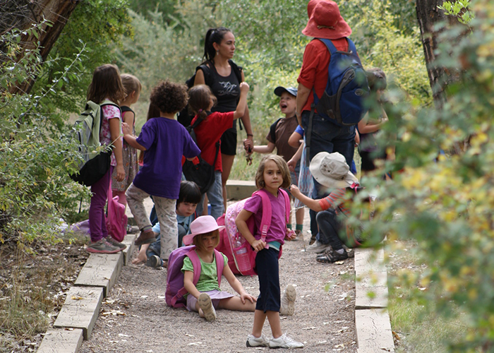 Children gather along a trail