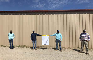 4 standing 6 feet apart each. The middle two people are holding large note pad.